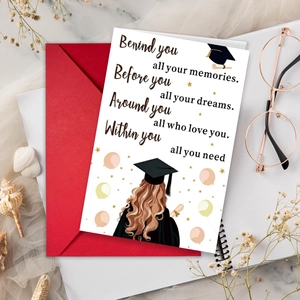 Detailed graduation greeting card with red envelope and inspirational quote on desk