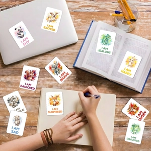 Detailed set of 18 watercolor animal emotion flashcards on a natural wooden tabletop