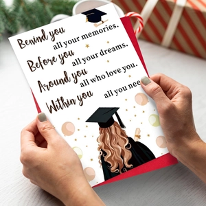 Close-up of graduation card with female graduate illustration and a red envelope