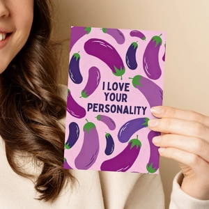 Greeting card with eggplant pattern and 'I love your personality' text held by hand