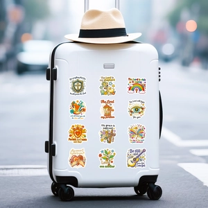 Religious Bible verse stickers with cross and rainbow motifs on a white suitcase
