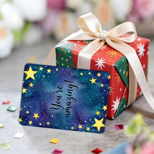 Close-up of You're Amazing card on a festive red gift box with a white silk ribbon