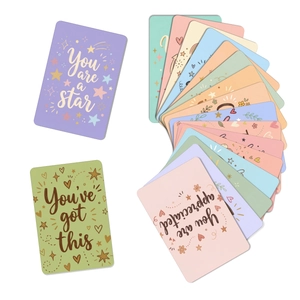 Macro detail of multi-color positive affirmation cards with rounded edges and star patterns