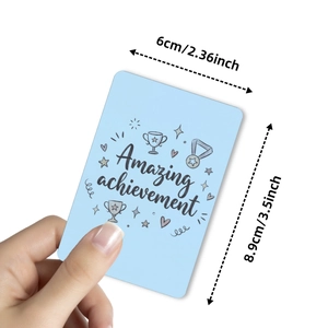 Handheld light blue achievement card with motivational text and hand-drawn icons
