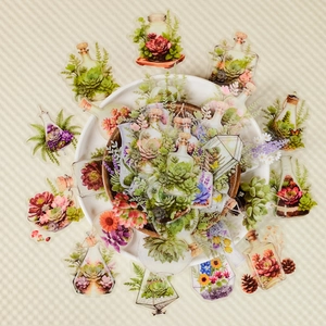 Macro shot of waterproof PET floral stickers with watercolor succulents in glass jars