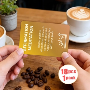 Close-up of 18 meditation affirmation cards held in hands at a cozy cafe setting