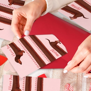 Detail of cute dachshund greeting card with 'I Love You Much' text and red envelope
