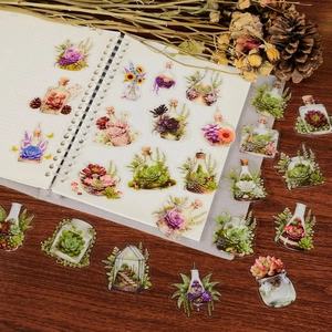 Detailed view of clear floral PET stickers applied on a grid notebook for decoration