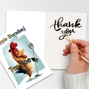 Cute cartoon rooster greeting card set with envelopes and a wooden pen on a desk