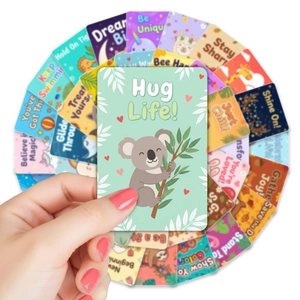 Close-up of hand holding a cute animal lunch box note with inspirational message for kids