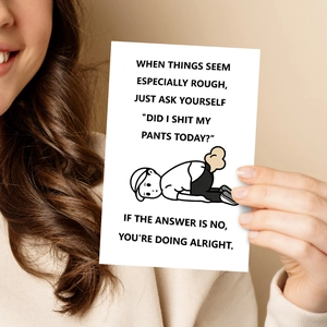 Detailed view of hand holding a minimalist humorous greeting card with funny quote