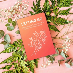 Relaxing meditation card with Letting Go quote and bird illustration on pink wood background