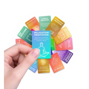Close-up of hand holding colorful meditation cards for daily relaxation and breathing