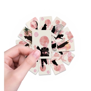 Close-up of pink watercolor cat silhouette greeting cards held by a hand for gift decoration