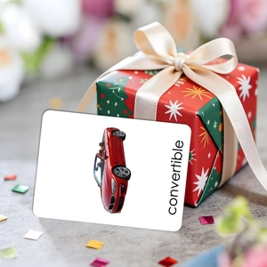 Educational flashcard featuring a red convertible car next to a festive Christmas gift box