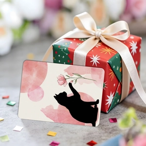 Artistic cat silhouette greeting card with pink watercolor floral design next to a gift box