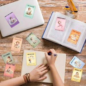 Lifestyle shot of watercolor emotion regulation cards on a desk with a laptop and books