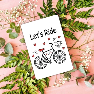 Cartoon bicycle motivational card with heart patterns on pink wood grain backdrop