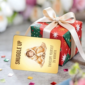 Macro detail of Snuggle Up child card with watercolor illustration and gold finish