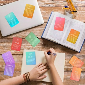 Set of 18 rainbow gradient healing quote cards for meditation on a cozy wooden desk