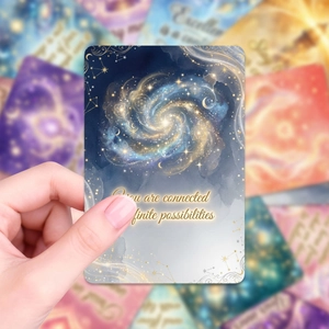 Macro detail of a galaxy-themed oracle card with golden spiral and celestial patterns