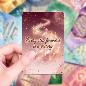 Detail of pink-purple gradient oracle card with gold starlight and victory quote