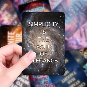 Inspirational galaxy card saying Simplicity is the soul of elegance with starry nebula