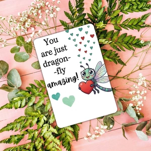 Detail of dragonfly gift card with positive pun on pink wood and floral background