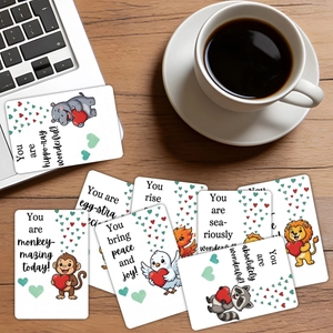 Detailed view of animal-themed motivational cards scattered on a wooden desk