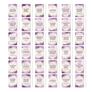 Flat lay of 36 daily affirmation cards with purple watercolor design and positive quotes