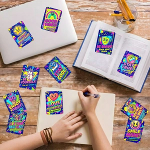 Inspirational cartoon stickers with vibrant colors and positive quotes on a laptop