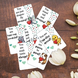 Flat lay of cartoon animal motivational cards with puns on dark vintage wood background