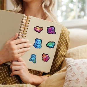 Vibrant neon animal stickers featuring panda and whale on a beige notebook cover