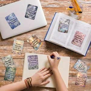 Detail of inspirational nature cards on a desk with Monet-style garden illustrations