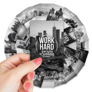 Close-up of black and white inspirational cards with motivational English text and city photos