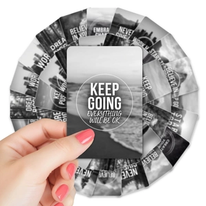 Close-up of black and white inspirational quote cards with minimalist scenery and typography