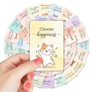 Close-up of cute watercolor cat affirmation cards with motivational quotes for kids