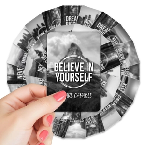 Macro detail of black motivation cards with white inspiring text and rounded corners