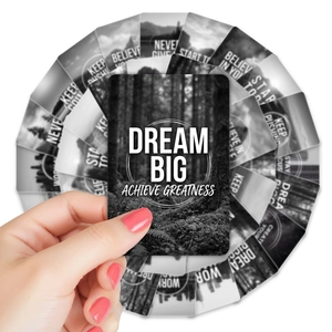 Macro detail of hand holding motivational black and white landscape cards with quotes