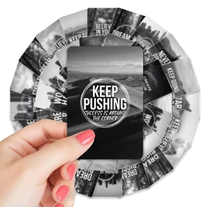 Handheld display of black and white inspirational affirmation cards with artistic text