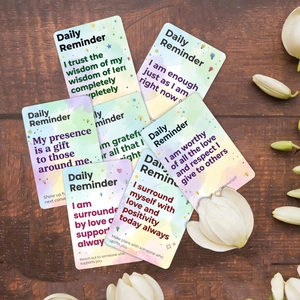 Close-up of daily reminder cards with watercolor design on a rustic wooden surface