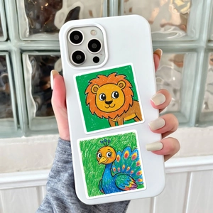 Close-up of cute cartoon lion and peacock stickers on a white smartphone case