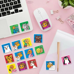Detail of colorful cartoon animal stickers with crayon texture on a laptop and mouse