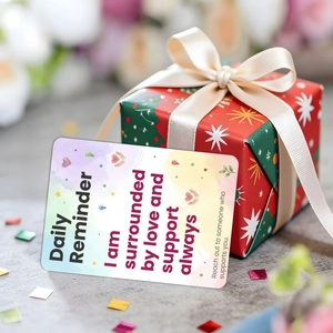 Close-up of inspirational daily reminder card in a festive red Christmas gift box