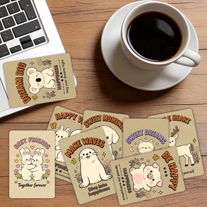 Close-up of hand-drawn animal cards with positive quotes on a cozy wooden workspace