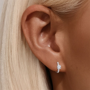 Gros plan de boucles d'oreilles créoles en argent S925 avec moissanite sur l'oreille