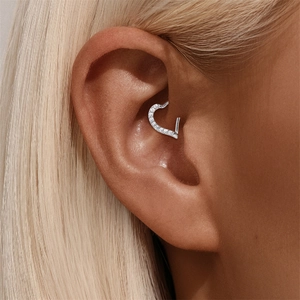 Close-up of S925 sterling silver heart-shaped daith piercing ring with cubic zirconia stones