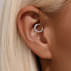Macro view of S925 silver Daith piercing ring with triple-row inlaid white zircons