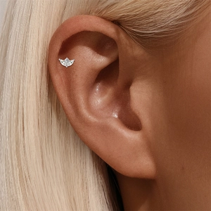 Close-up of S925 sterling silver helix piercing with marquise cut moissanite flower detail