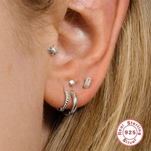 Minimalist S925 sterling silver earring set with stud and hoop styles on female model